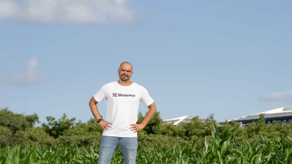Thai Sade, Bloomx's CEO standing in a corn field.
